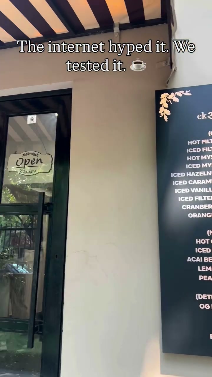 ek अंDAAZ storefront with striped awning and menu board